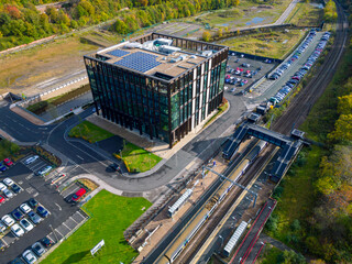Aerial view over Kirkstall Forge Train Station, Leeds, with car park and offices