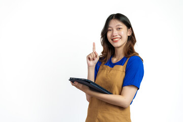 Using tablet, Cheerful young pretty asian woman blue t-shirt and apron coffee owner isolated on white background. checking order online