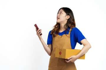 Young pretty asian woman with apron holding packages box of product for delivery sme entrepreneur owner isolated on white background. Using mobile
