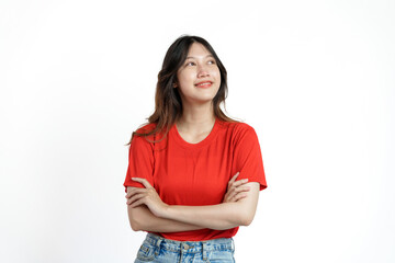 Happy pretty young asian woman red t-shirt isolated white background. looking blank area, copy space