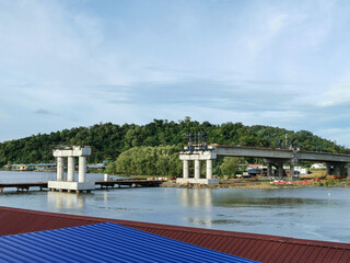 Fototapeta na wymiar Construction of the bridge across a river at Kuala Abai, Kota Belud, Sabah, Malaysia.