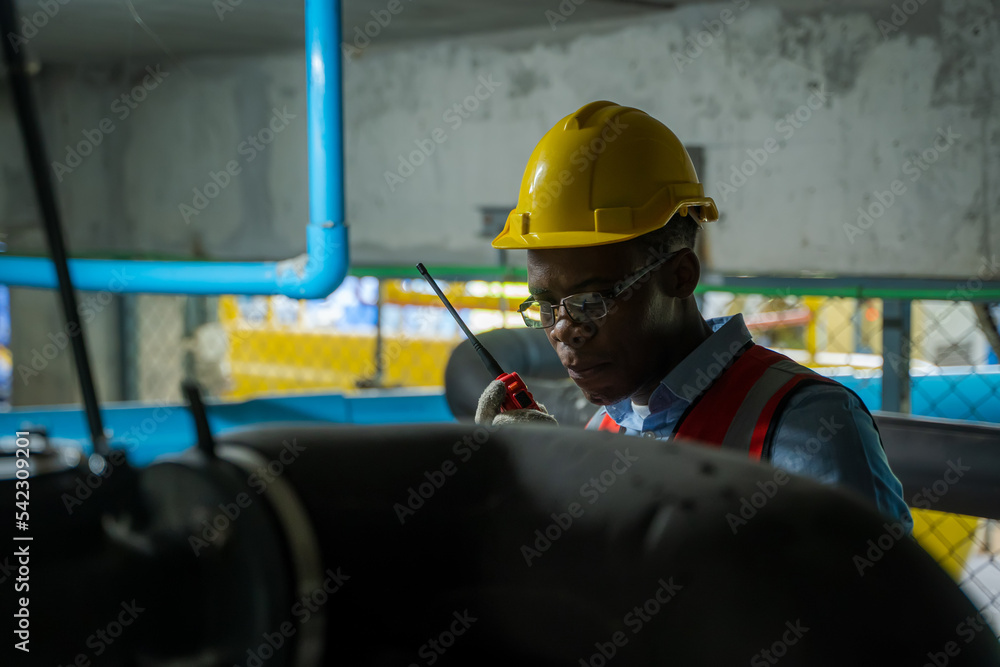 Aufkleber engineer checking the water pipe system in the factory,inspecting water valve for leaks in basement.