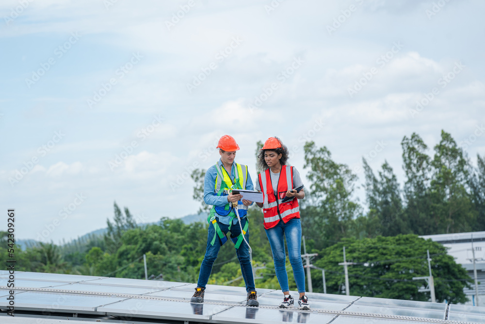 Poster Engineers checking the operation of the system solar cell on an building in an residential area,Photovoltaic module idea for clean energy production.
