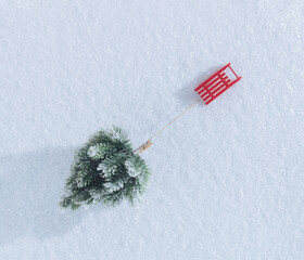 Red Santa's sleigh pulling Christmas tree on snow-white background. Winter holidays minimal concept.