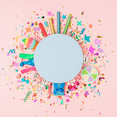 Colorful background for the celebration with various confetti, balloons, ribbons, fireworks and decorations on a pink background. Flat lai. Minimal concept of a celebration invitation. Copy space