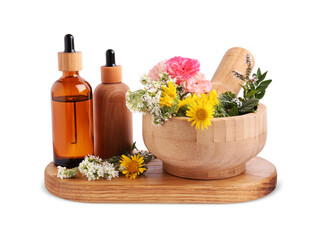 Bottles of essential oil and wooden mortar with different flowers on white background