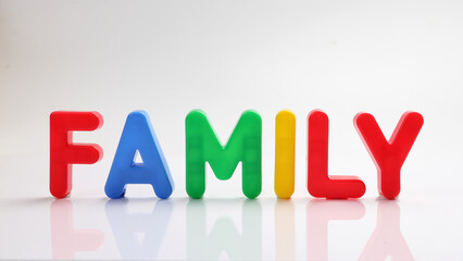 red green blue yellow plastic toy capital font letter alphabet family on white background copy text space concept