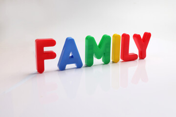 red green blue yellow plastic toy capital font letter alphabet family on white background copy text space concept