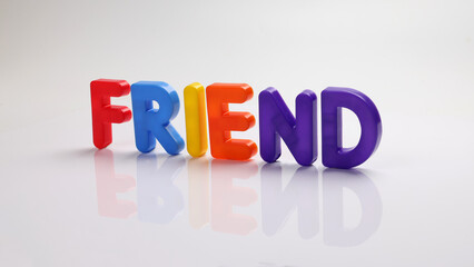 red green blue yellow plastic toy capital font letter alphabet friend on white background copy text space concept