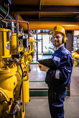 Portrait of refinery worker checking oil and gas product quality.