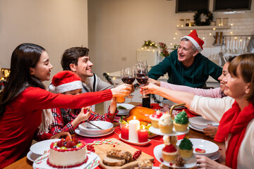 Multi-ethnic big family celebrating Christmas party together in house. 