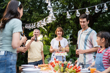 Multi-ethnic big family having fun, enjoy party outdoors in the garden.