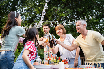 Multi-ethnic big family having fun, enjoy party outdoors in the garden.