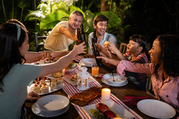 Multi-ethnic big family having fun, enjoy party outdoors in the garden.