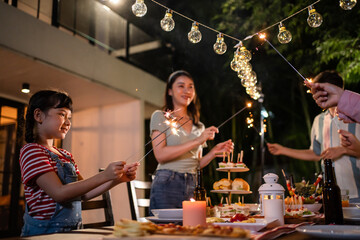 Multi-ethnic big family having fun, enjoy party outdoors in the garden.