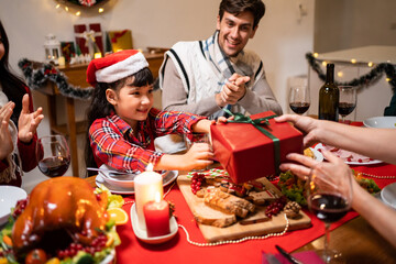 Multi-ethnic family exchanging presents during Christmas party at home.