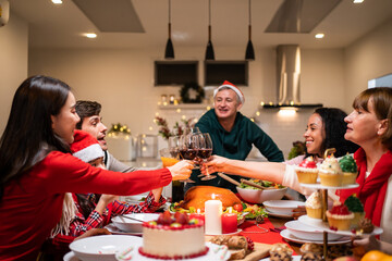 Multi-ethnic big family celebrating Christmas party together in house. 