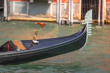 Obraz premium Ornate Gondola in Grand Canal pier at sunny day, Venice, Italy
