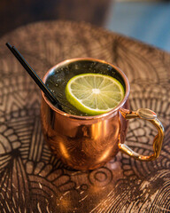 Refreshing Moscow mule drink on a decorated shiny surface