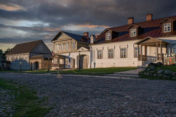 View of historical merchant buildings of estates on the main street of Izborsk Pechorskaya Street on a summer sunny day, Izborsk, Pskov region, Russia