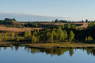 Fototapeta na wymiar View of Gorodishchenskoe Lake in the Izborsko-Malskaya Valley on a sunny summer morning, Izborsk, Pechersk district, Pskov region, Russia