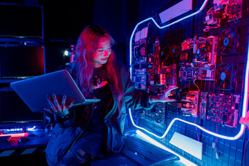 Fototapeta na wymiar Program or cyber security development concept. Young woman working with monitors and checking system safety from cyber attack, hacker, programmer online error. work at night.