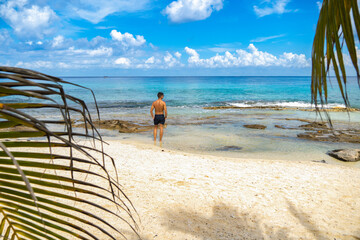 Man on his back looking at the sea. Tropical landscape.