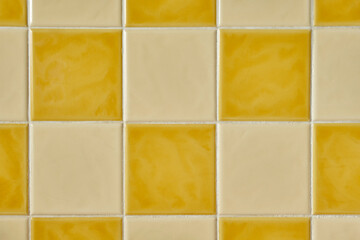 Close up photo of original retro 1970s tiles. Square orange and yellow checkered tiles. Vintage...