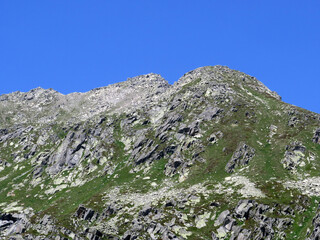 Rocky mountain peaks Poncione di Fieud (2696 m) and Fibbia (2738 m) in the massif of the Swiss Alps...