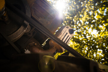 Diesel engine of a walk-behind tractor with a belt drive close-up. Foreshortened view from below...