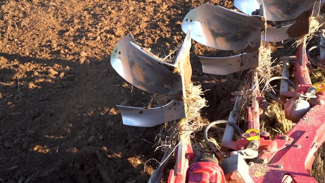 Heavy machinery plowing soil before planting seeds, view from cabin