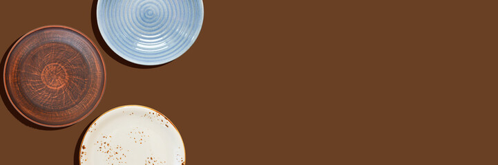 eco friendly handmade ceramic tableware top view with copy space for text and design, clay empty plate flat lay, cutlery and table setting, minimalism and ceramics tableware