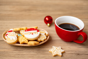 Merry Christmas with homemade cookies and coffee cup on wood table background. Xmas eve, party, holiday and happy New Year concept