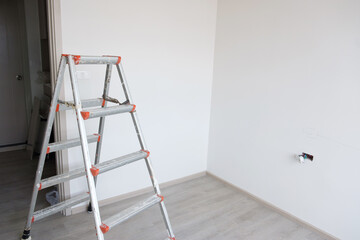 Ladder at construction site building. Renovation, Repair and development of home and apartment concepts