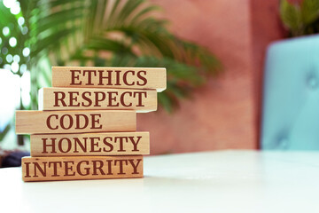 Wooden blocks with words 'ethics, respect, code, honesty, integrity'. code of conduct
