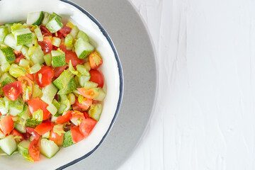mediterranean salad in white bowl healthy food on table