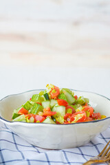 mediterranean salad in white bowl healthy food on table