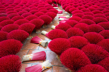 Incense sticks drying outdoor in Vietnam. The middle of image is walk a way with bundle of incense sticks that waiting to expand for drying. 