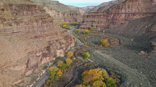 Aerial view through Nine Mile Canyon with road winding through the Utah landscape.