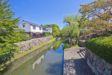 Fototapeta na wymiar Japanese-style boat takes tourists around Hachiman-bori canal in Omihachiman town.
