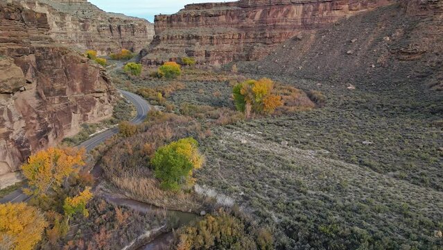 Flying along road in Nine Mile Canyon in Utah during Fall slowly getting closer to the ground.