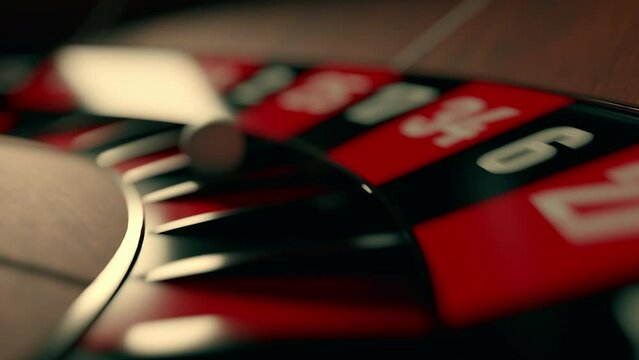 Close up of roulette wheel at the casino in motion. The wheel ball is spinning. Concept of casino and gambling.