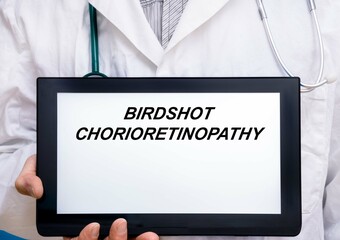 Birdshot Chorioretinopathy.  Doctor with rare or orphan disease text on tablet screen Birdshot Chorioretinopathy