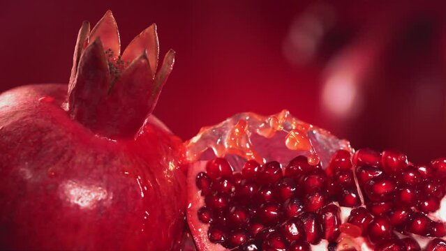 Slow Motion Shot of Pomegranate Juice Splashing through Pomegranate Slices