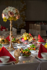 Festively laid table in the restaurant. Banquet table. Table setting with flowers. Flower arrangement on the festive table. Table setting with flowers.