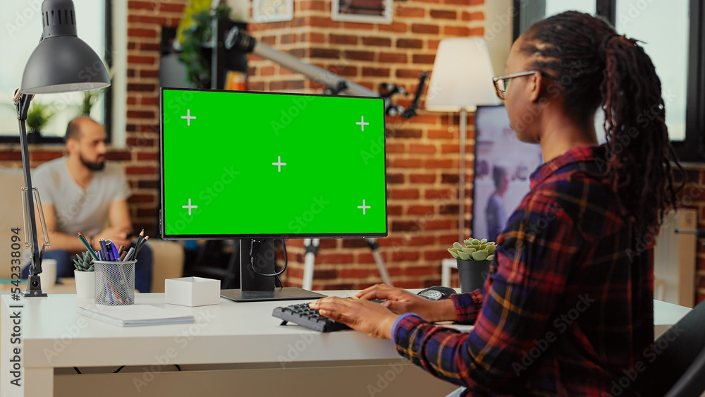 Poster african american person using monitor to check with greenscreen template on isolated display, lookin