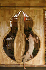 Happy family lifestyle. Mother and child in a bamboo house have fun and enjoy their holidays in...
