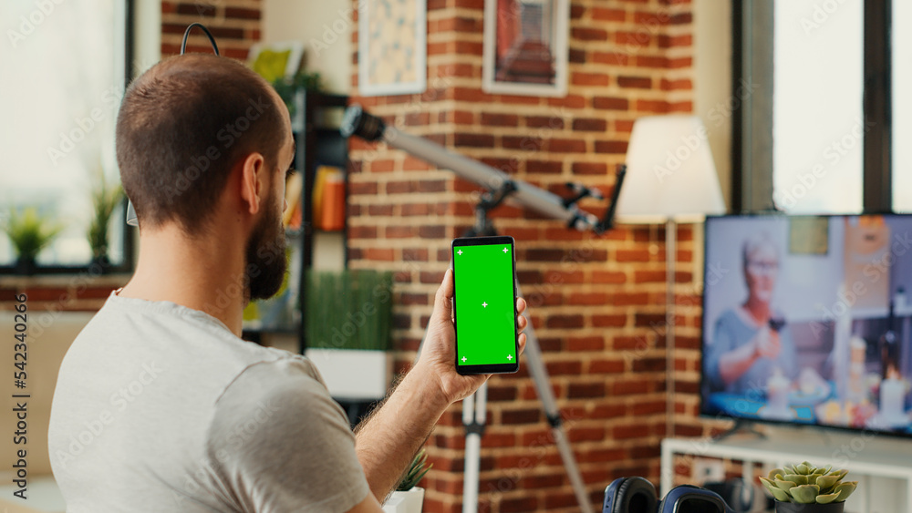 Poster office worker analyzing smartphone with greenscreen template, using isolated display with chroma key