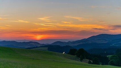 Scenic view of green field in mountains of the Black Forest, Germany at sunset