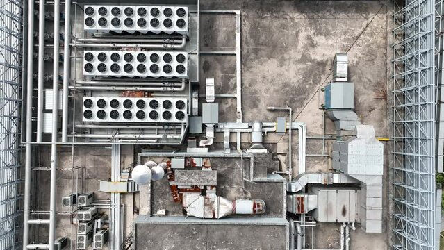 The air conditioner system on the building roof. Drone aerial view. Complicated air conditioning system on building top. Pipelines and machines.  Industry, business, economy concept b-roll footage.